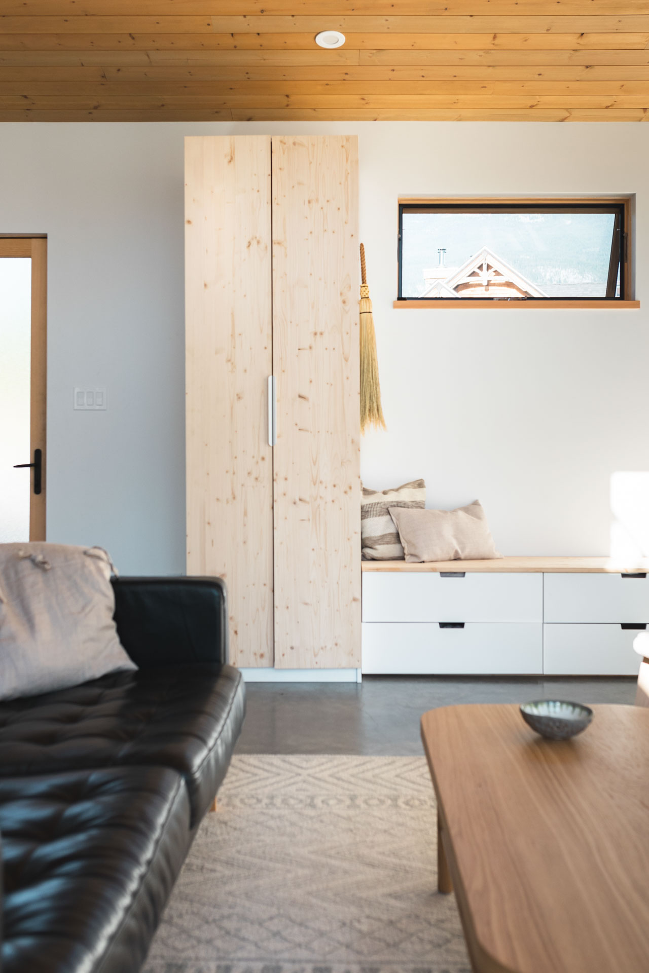 Minimalist wood and white interior of a custom home built by Eisenhauer Woodworks in Kaslo, BC
