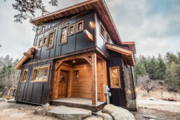 Black and wood exterior of a custom home built by Eisenhauer Woodworks in Kaslo, BC