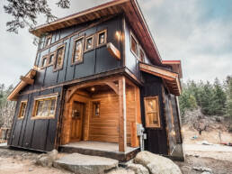Black and wood exterior of a custom home built by Eisenhauer Woodworks in Kaslo, BC