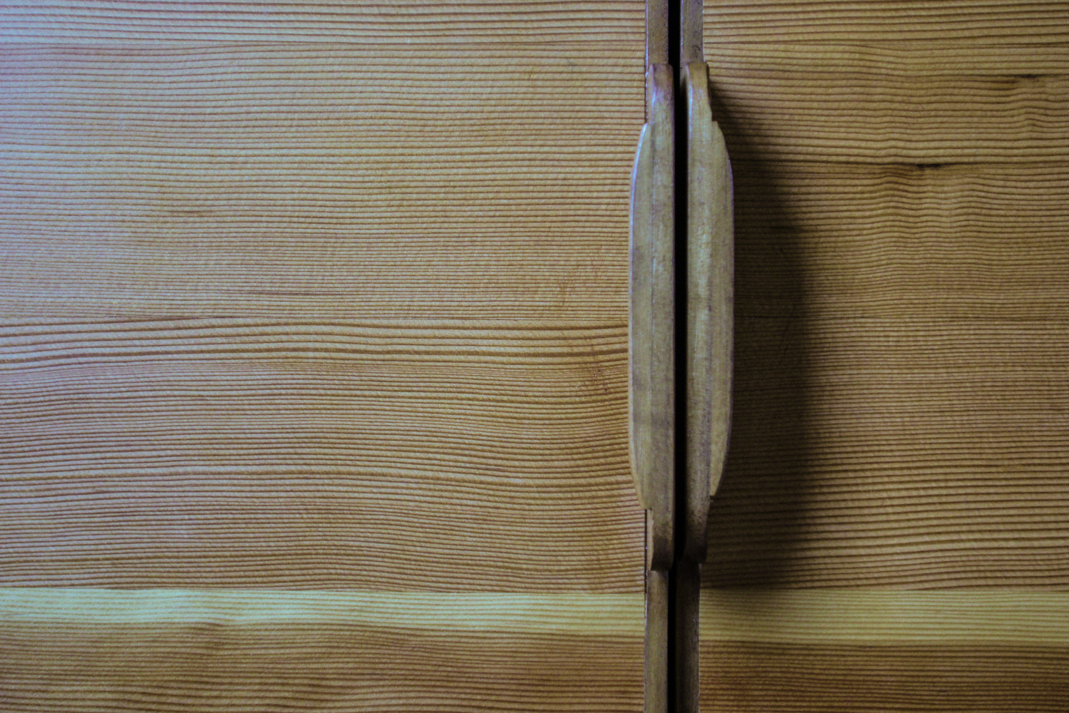 Close up of wood handles on a custom cabinet made by Eisenhauer Woodworks.